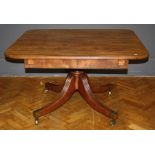 A late George III mahogany drawleaf table, the figural reeded top with rounded corners carved on a