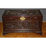 A mid 20th century camphor lined chest, the rectangular hinged top and panel sides carved in shallow
