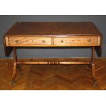 A mahogany sofa table, the reeded flapped top with rounded corners over a pair of frieze drawers