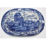 An early 19th century blue and white transferware meat platter, decorated with a goatherd beside