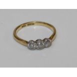 An 18ct three stone diamond ring, the graduated old cut stones with total diamond weight of