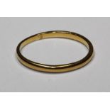 A gold band, size O, approx. 1gm, tests as 22ct, hallmarked present but obliterated