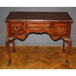 A George III style mahogany lowboy, the oblong top over three drawers raised on cabriole legs,