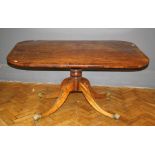 A Regency mahogany breakfast table, the rectangular crossbanded tilt top, on a baluster column, four