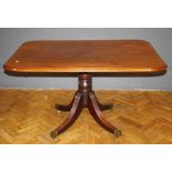 A late George III mahogany breakfast table, the oblong thumb moulded snap top raised on a turned