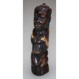 A carved ebonized ivory figure of a kneeling woman. H13cm