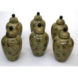 A set of Chinese decalcomania style tapered vases and covers decorated with birds and foliage,