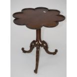 A small George III style occasional table, the lobed circular top raised on column and scrolling