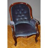 A Victorian walnut framed, deep blue button velour upholstered spoon back salon armchair, with