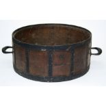 A coopered oak bushel measure of shallow circular form with applied handles, branded marks for