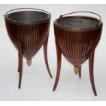 A pair of Edwardian mahogany jardinières the open tapered bodies having brass linings raised on