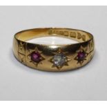 A three stone, gypsy set ruby and diamond ring, hallmarked 1906, Chester, size P 1/2