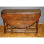 An oak gateleg table ,the flapped top raised on square section legs, 18th century and later, L124cm