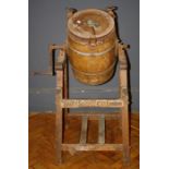 A Dairy Supply Co of London coopered churn raised on tapered dual end supports, W70cm