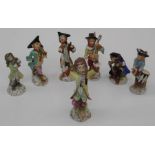 An early 20th century Sitzendorf porcelain seven piece monkey band, including conductor with