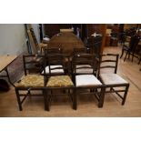 A round tilt top table along with 2 carver chairs and 4 dining chairs
