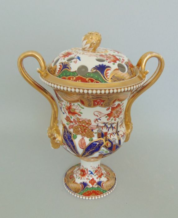 A Spode Vase and Pierced Cover with an Acorn finial. The gilt handles with goats heads. White