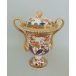 A Spode Vase and Pierced Cover with an Acorn finial. The gilt handles with goats heads. White