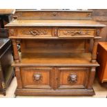 Victorian oak buffet unit with decorative top rail, two top drawers carved with vine detail, and