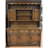 Reproduction solid dark oak George III kitchen dresser with three plate racks inbetween two spice