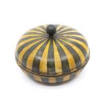 A George III papier mache circular box and cover, knop finial, painted with black and yellow stipes,