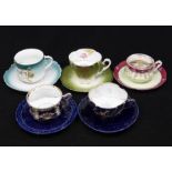 A collection of five Continental moustache cup and saucers to include: dark green ground example