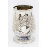 A George III Provincial silver baluster mug / tankard, the body profusely chased and engraved with