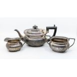 A Georgian style three piece silver tea service, comprising teapot, sugar bowl and milk jug, gadroon