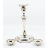 A George III Neo-Classical candlestick, urn shaped sconce above tapering stem on raised oval foot,