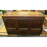 An early 18th Century mule chest in oak, having two bottom drawers and wooden knob handles, with