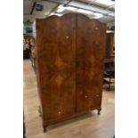 A walnut front 1930's wardrobe with two opening doors, one with internal mirror to reveal a