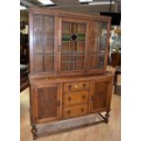 1930s oak dresser with stained glass detail to top display door with three central drawers with