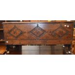 A 17th Century oak coffer of small proportions, carved to front, with three diamonds with date and