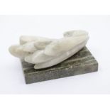 A hardstone flower on a marble plinth, length of flower 18cm