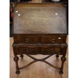 A 1920 oak reproduction of a Queen Anne bureau, with two single drawers, one above the other, x