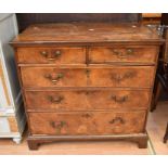 A George III walnut chest of two above three drawers, with brass swan neck handles, bracket feet