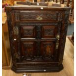 A late 18th Century dark wood, panel backed corner cabinet, heavily decorated, having a pencil