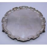 An Elizabeth II silver tray with pie-cluster rim, on claw and ball feet, enger presentation