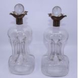 A pair of silver mounted "glug glug" glass  decanters