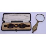 A cased pair of tortoishell lunettes and a magnifying glass