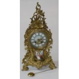 A late 19th century/ early 20th century French gilt metal mantle clock, the Rococo balloon case,