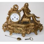 A late 19th century French gilded spelter mantle clock with figural surmount beside a drum case