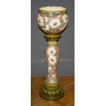 A Burmantofts Faience Jardinaire and stand, decorated in shallow relief with bold white blooms and