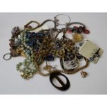 A large selection of costume jewellery to include necklaces, brooches and numerous other items (some