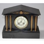 A late 19th century French mantle clock, the gilt metal applied four column slate case enclosing