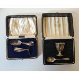 A silver Christening set cased and a silver egg cup and spoon, Sheffield 1935 and Sheffield 1924,