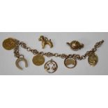 A 9ct gold charm bracelet, suspending a 1958 Sovereign, an 1885 half sovereign with later engraved