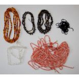 A selection of three garnet chip necklaces, several strands of pink shell beads, a strand of faceted