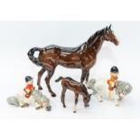 Two Norman Thelwell Beswick figures of children on horses along with a bay Beswick horse, with