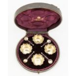 A set of four Victorian salts and matching spoons, circular with wavy rims, gilt interiors, the